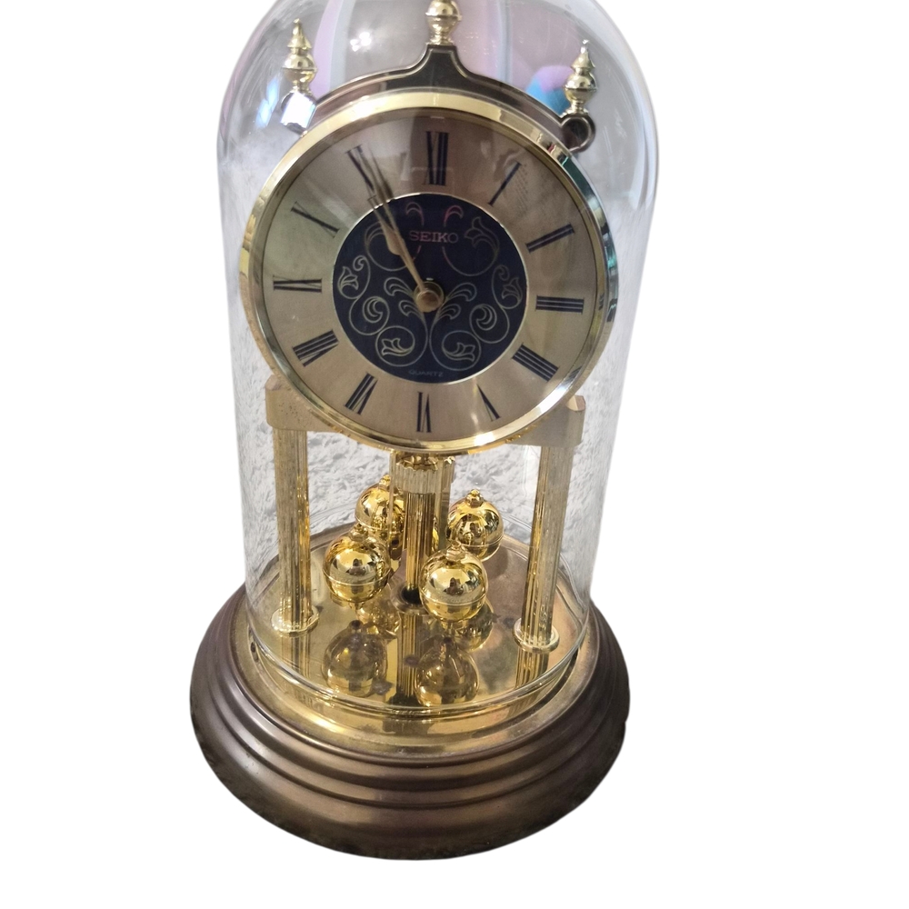 Seiko Gold and Black Rotating Pendulum Clock